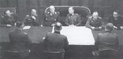 Facing left to right:
General von Schweppenburg
General von Blaskowitz
Field Marshal Sperrle
Field Marshal von Rundstedt
Field Marshal Rommel
Admiral Krancke

Backs to camera, left to right:
General Plocker
General Bluementritt
General Speidel